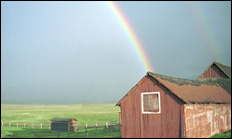 photo of rainbow over barn